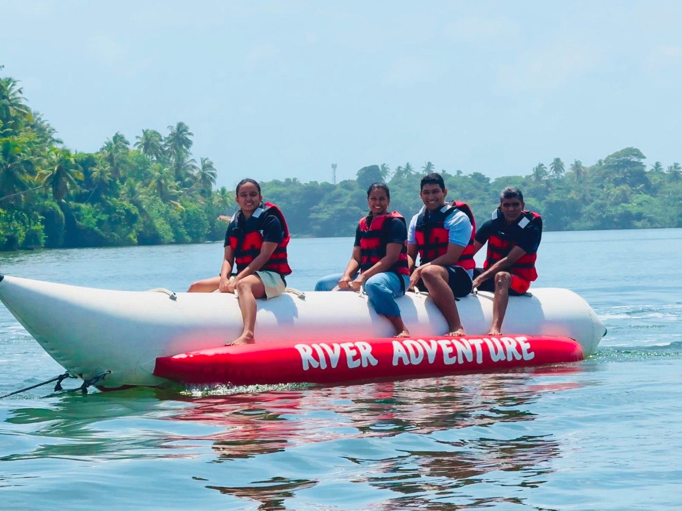 Riding a banana boat on the river with friends