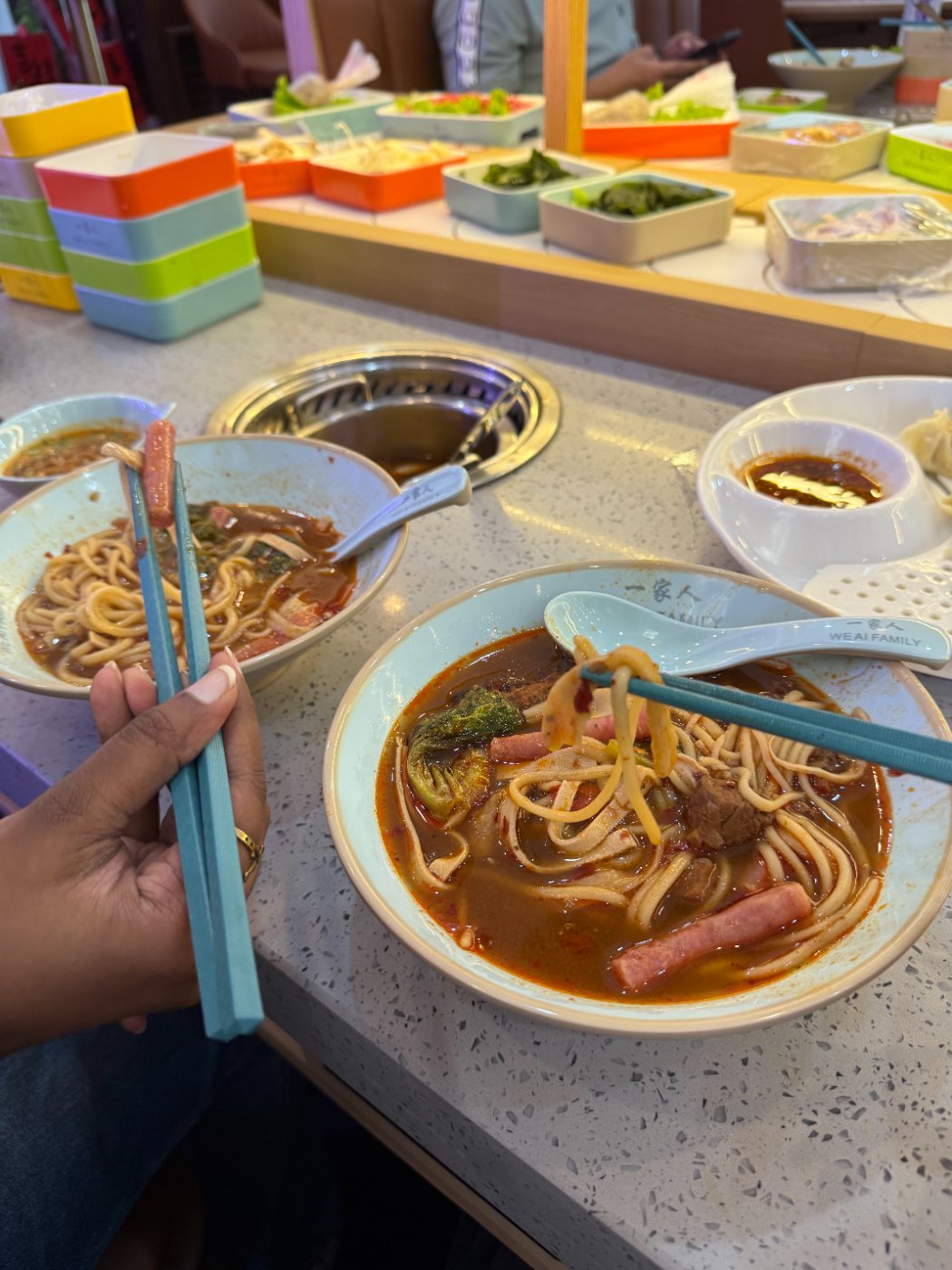 Bowls of noodles and chopsticks at a hot-pot restaurant